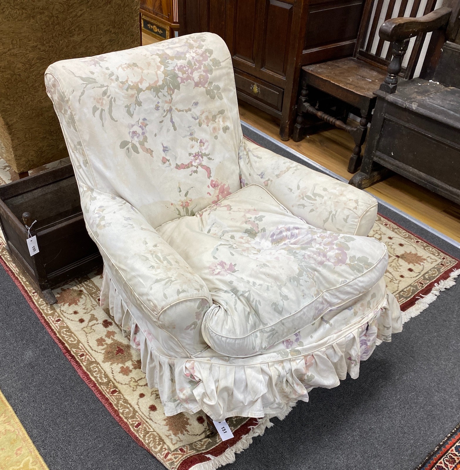 A Victorian mahogany armchair, upholstered faded beige foliate fabric, width 82cm, depth 80cm, height 86cm